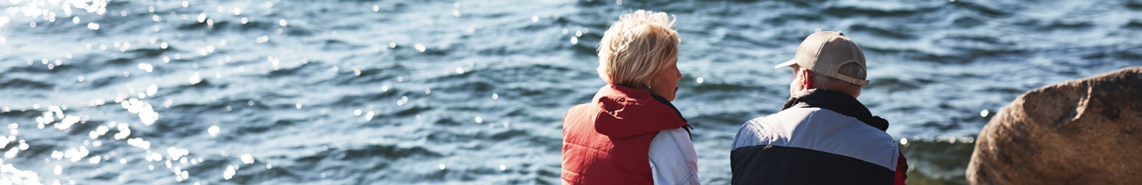 Senior couple sitting and looking into the ocean